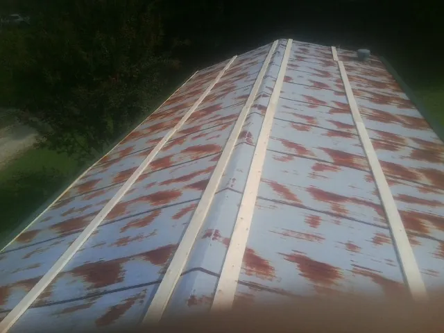 Rusted metal roof panels with new wood purlins before replacement — Storm Damage Roof Repair in Shoemakersville by Roofing Brothers