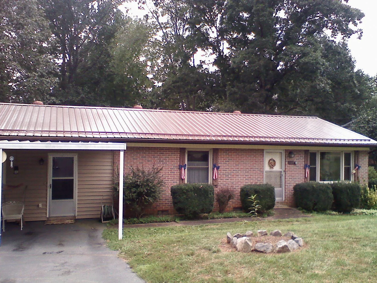 Bronze metal roof and carport on a brick ranch home — Roof Repair work by our crew in Shoemakersville